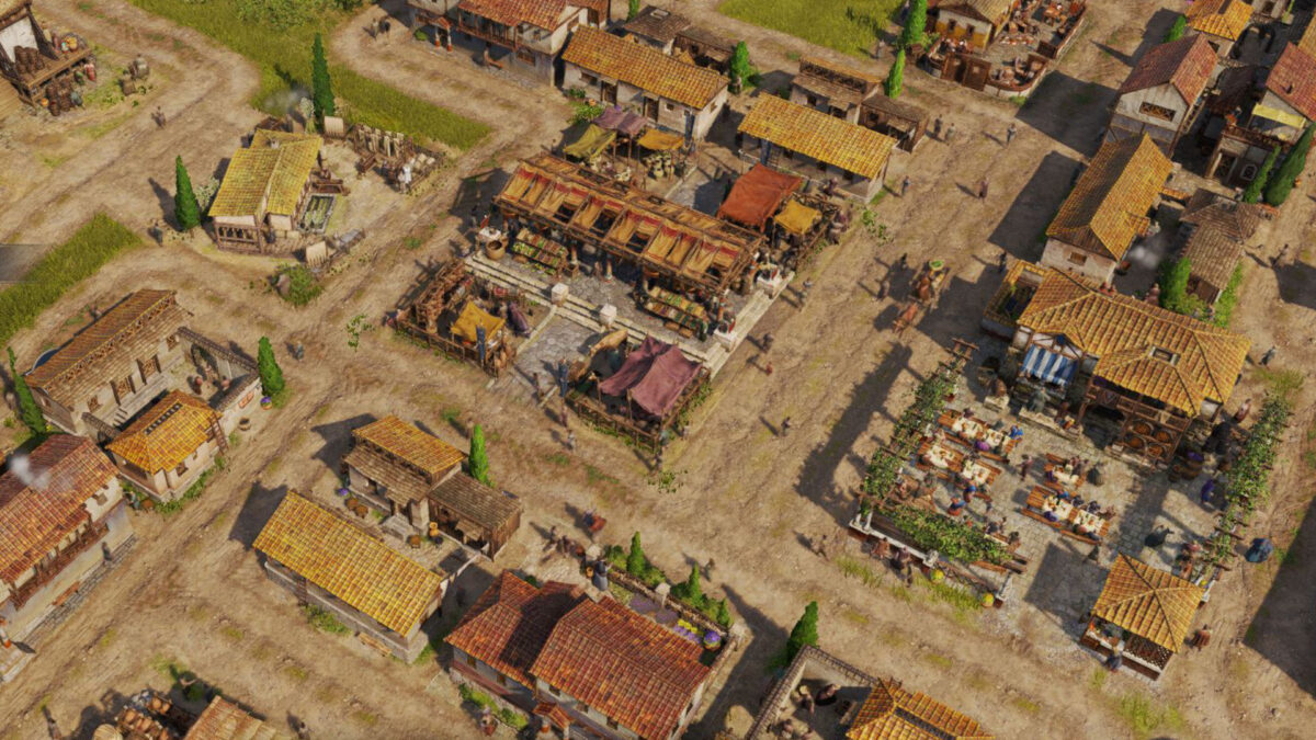 Mehrere Häuser, ein Markt und Läden aus der Vogelperspektive.