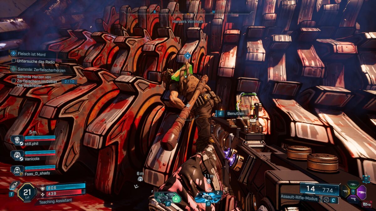 A person lies on top of a giant meat grinder.