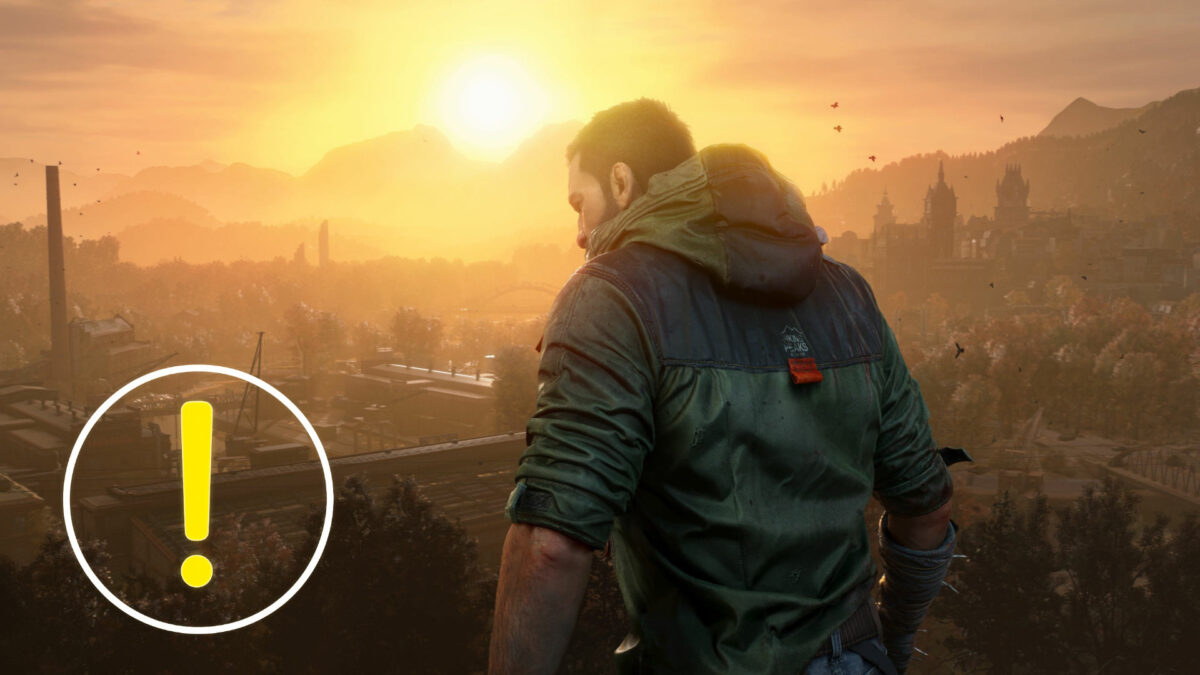 A man stands before a sunset, gazing into the distance.