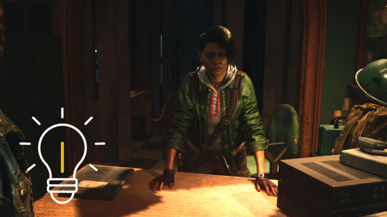 A woman in a green jacket leans on a table with both hands, a radio next to her.