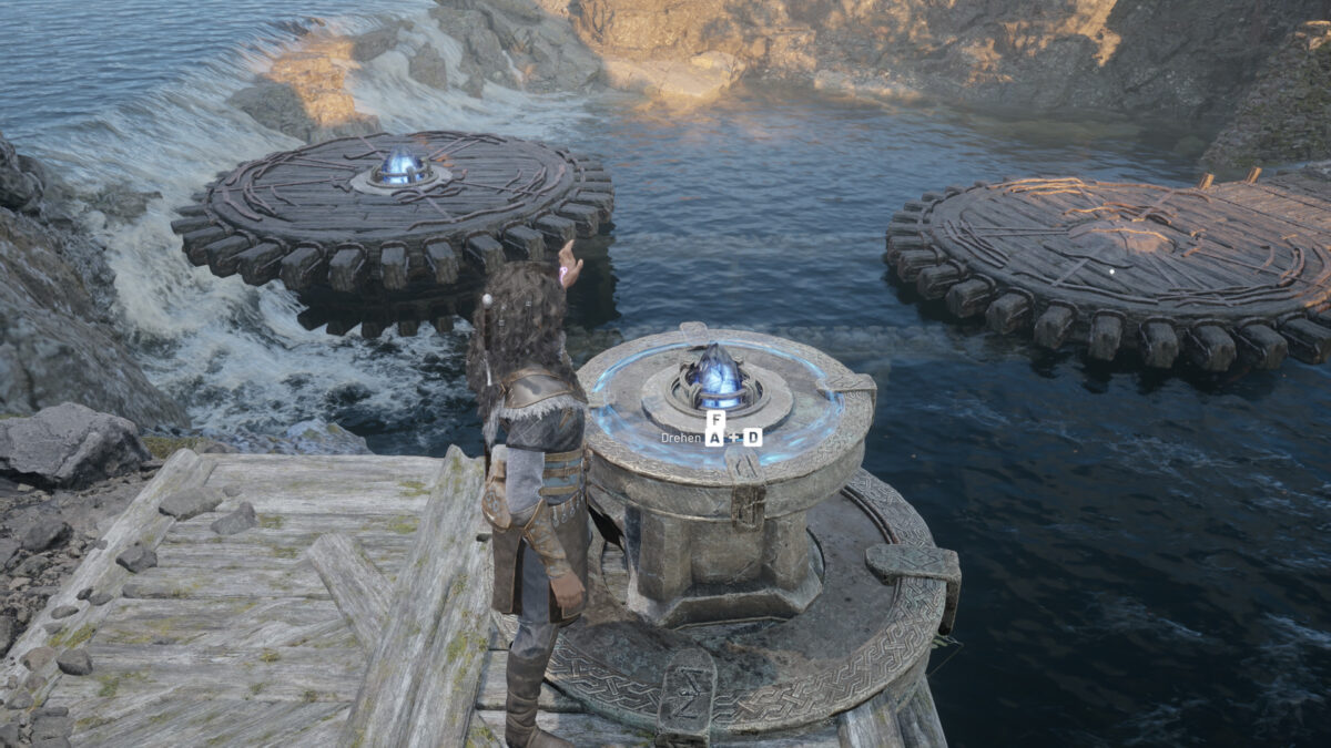 A woman stands at a stone control console with two large wooden platforms in the water.