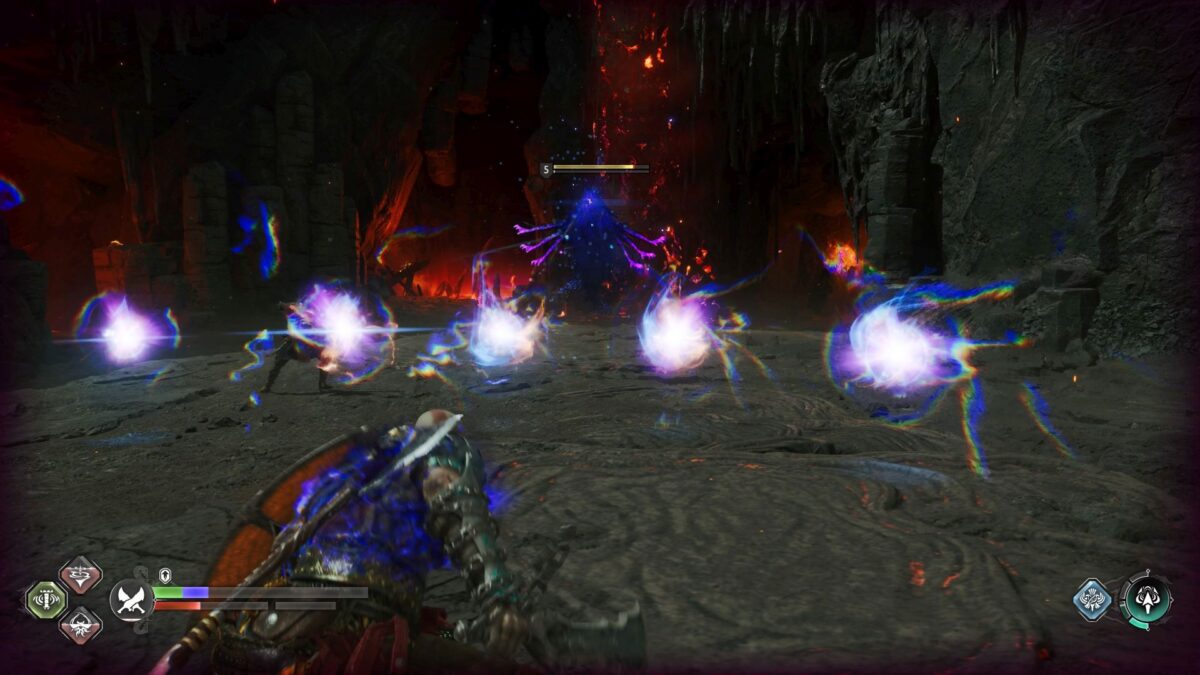Kratos weicht fünf leuchtenden Kugeln aus, die ihm in einer felsigen Arena von einem fliegenden Geist mit lila Armen entgegengeschleudert werden.