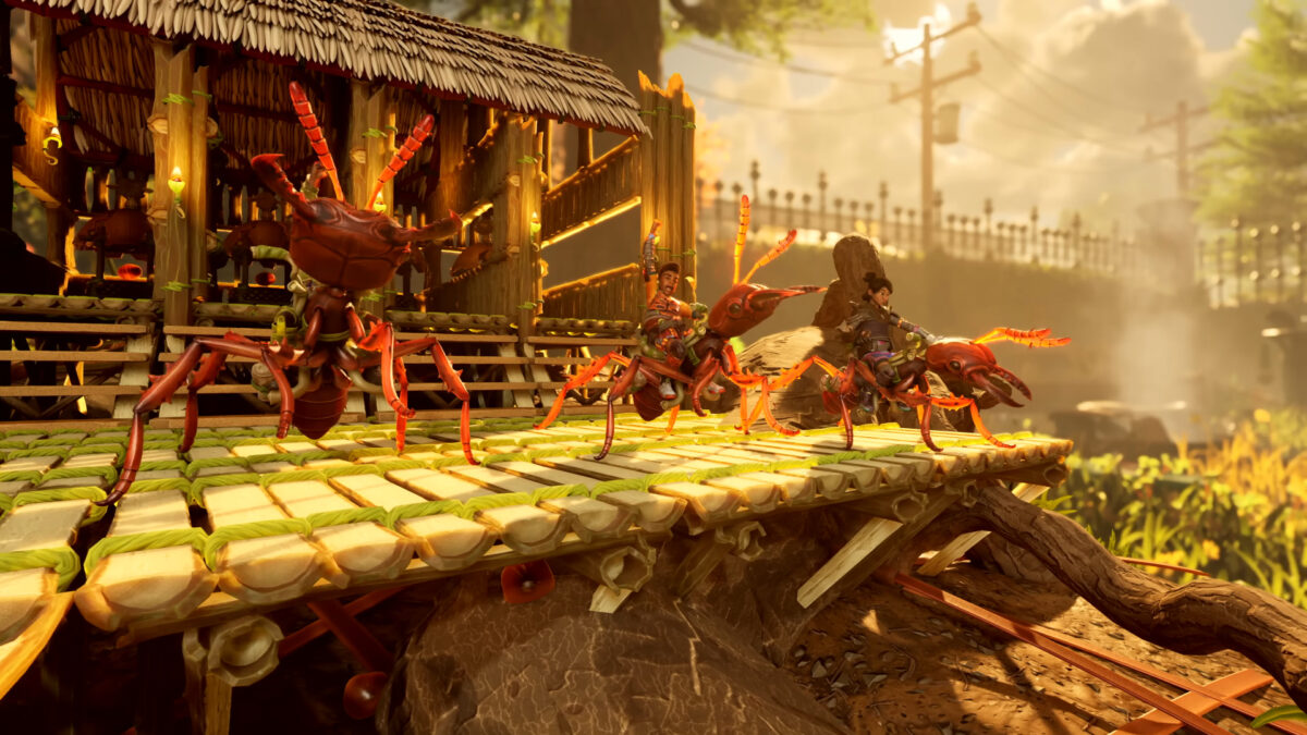 Several teenagers sit atop red ants in front of their base.