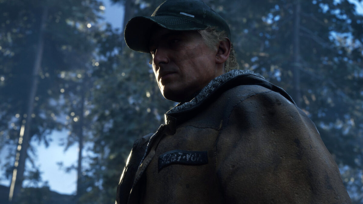 A man wearing a jacket and a baseball cap.