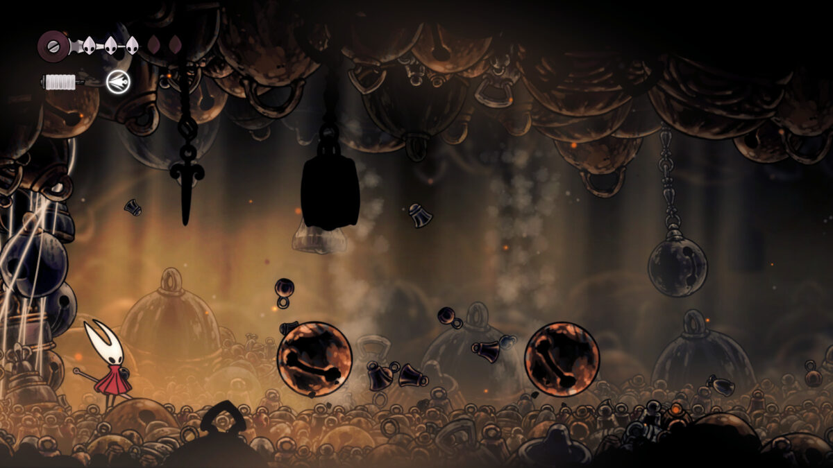 Hornet stands in a room filled with bells.