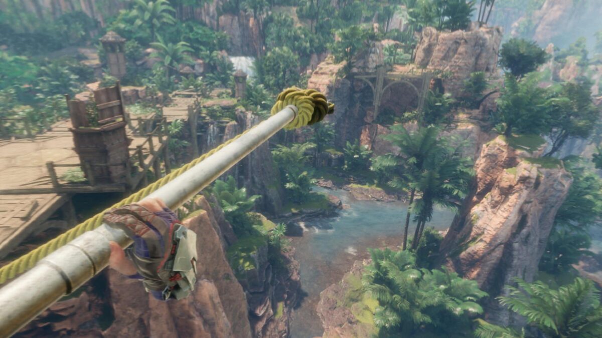 Die Spielfigur in Horizon Call of the Mountain hangelt sich an einem Seil über eine Schlucht.