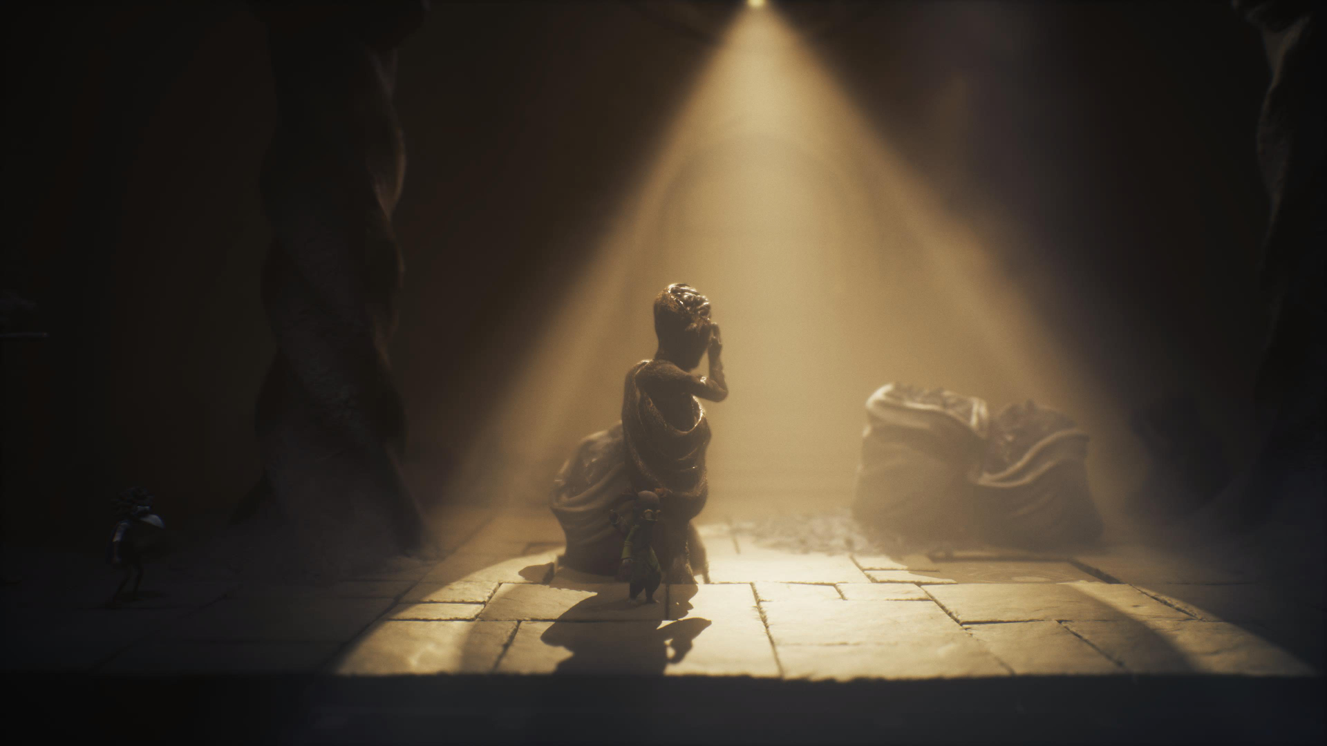 Two masked children hide behind a statue to avoid a beam of light.
