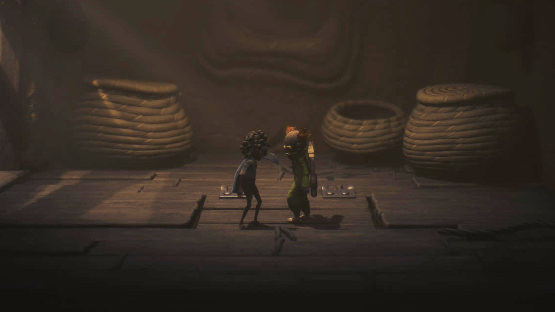 Two masked children stand on a wooden trapdoor.