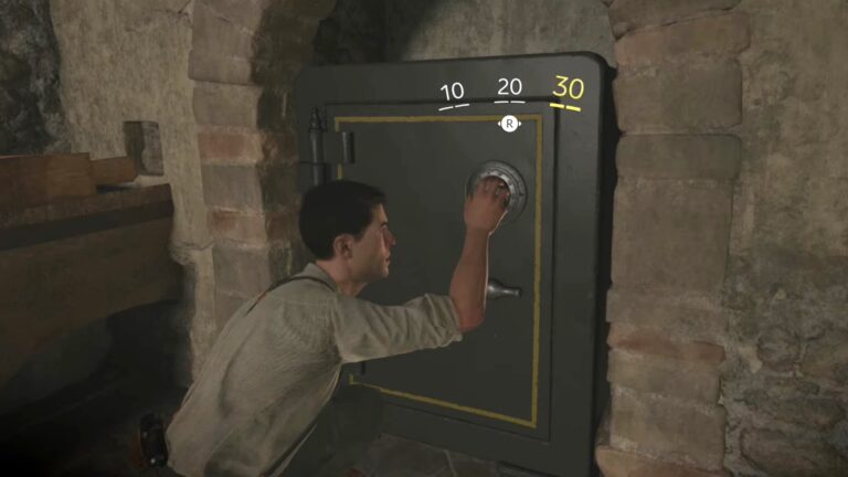 A man crouches in front of a safe, trying to open it.