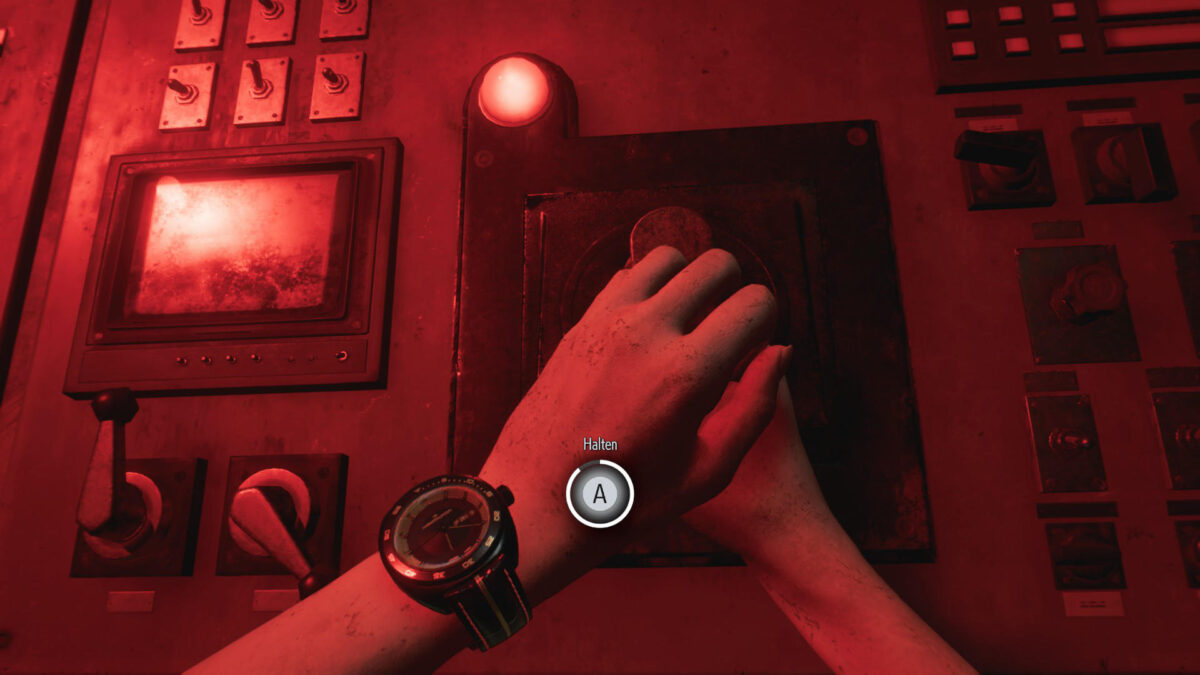 A hand on a lever surrounded by red light.