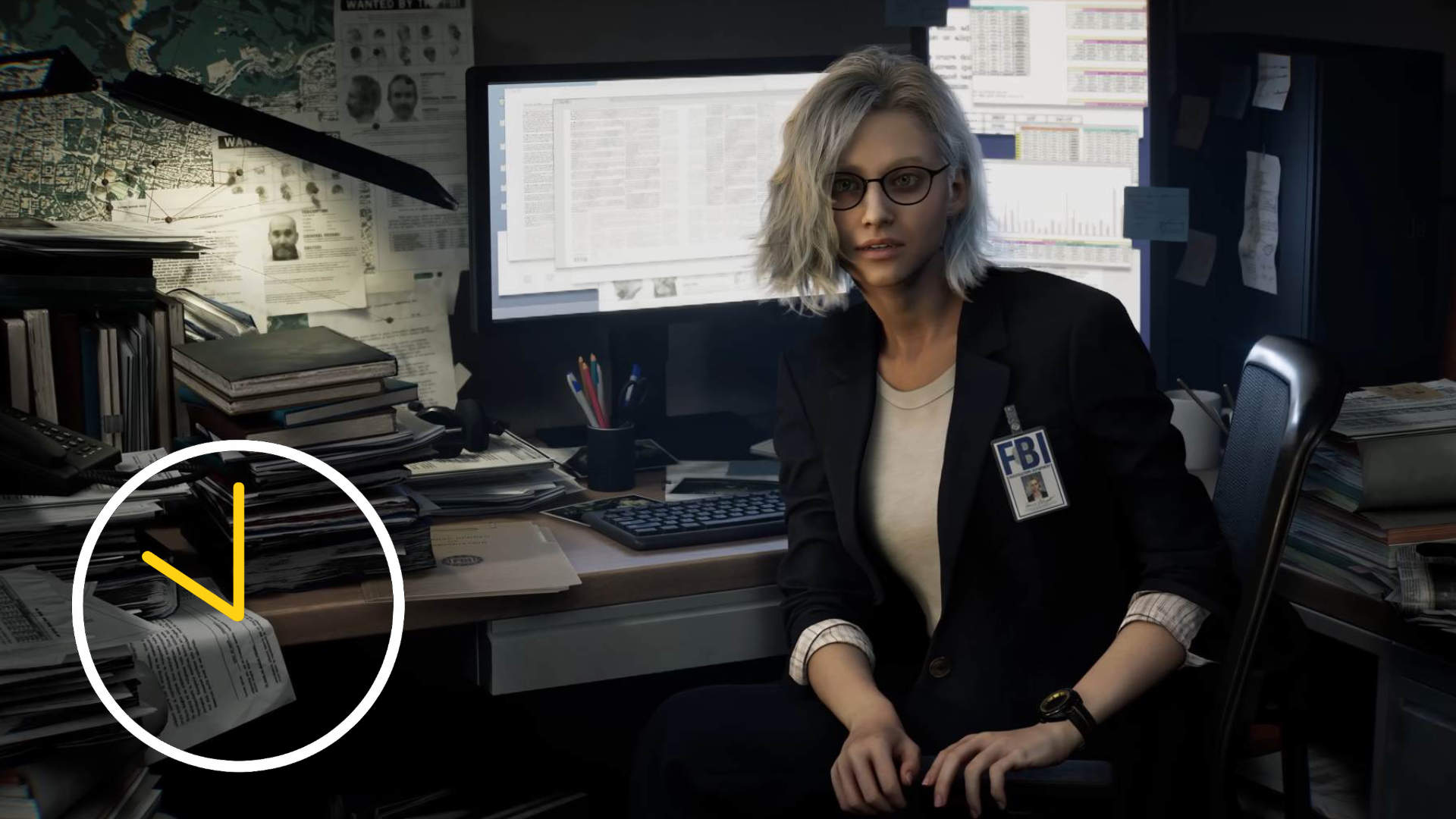 A blonde woman is sitting in front of a computer at work.