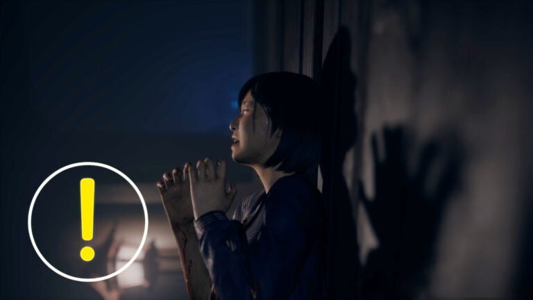 A schoolgirl leans against a wall, crying in despair.
