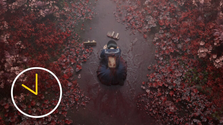 An Asian schoolgirl kneels on the ground in a torn uniform, blood seeping from wounds on her back.