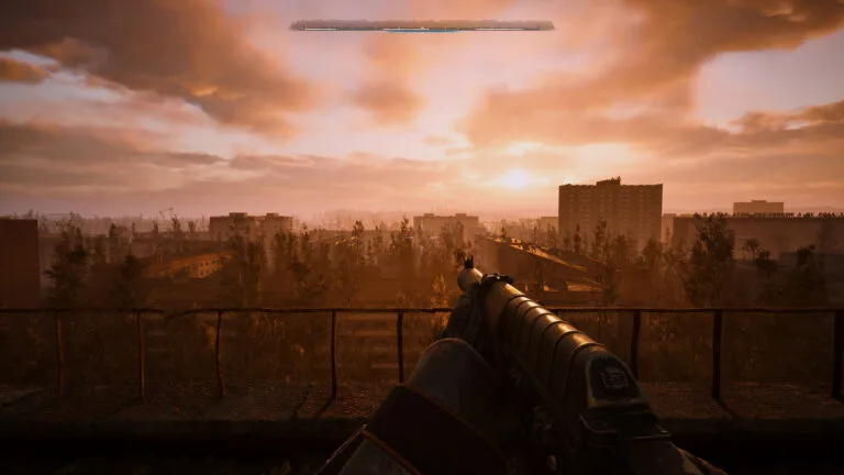 Ein Screenshot von Stalker 2 zeigt den Ausblick über einen Landschaft bei Sonnenuntergang.