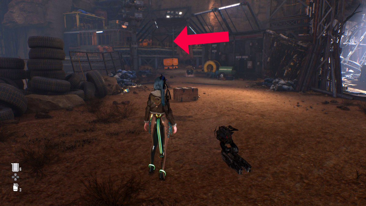 Protagonistin Eve steht in Stellar Blade auf einem Schrottplatz. Ein roter Pfeil zeigt auf eine Plattform.