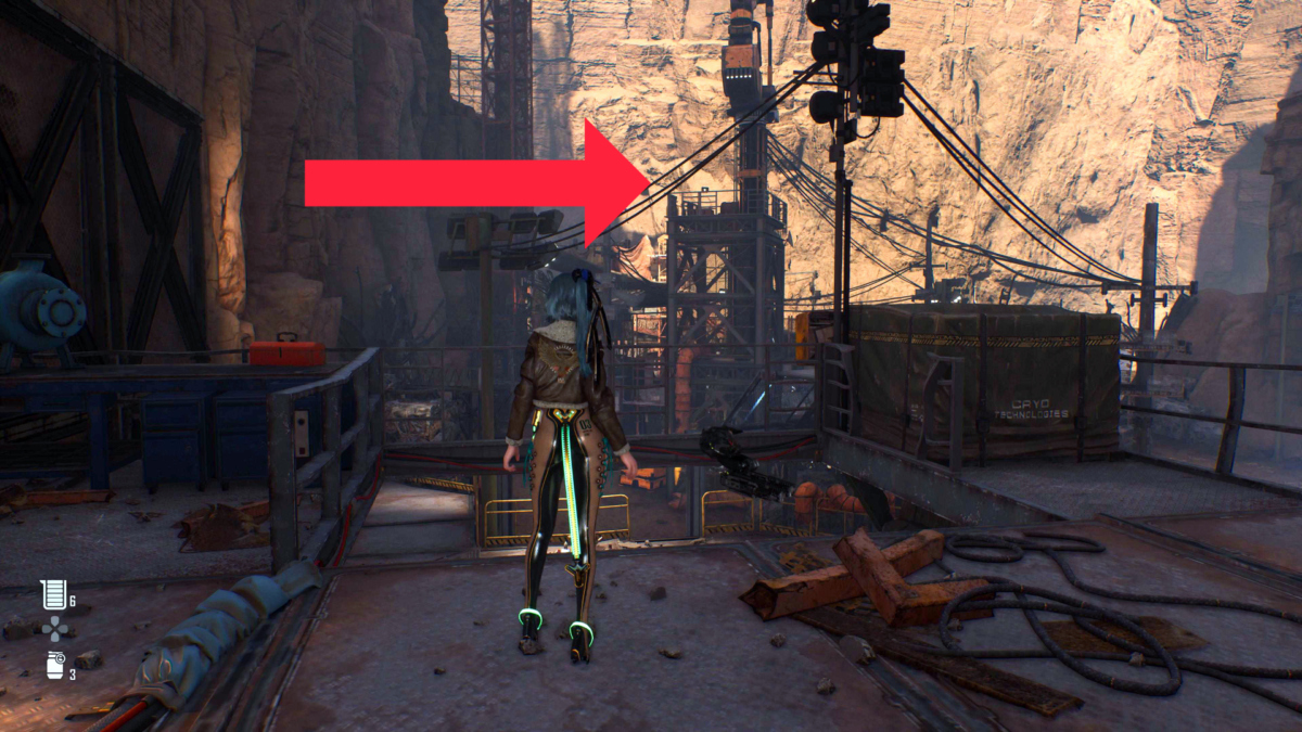 Protagonistin Eve steht in Stellar Blade auf einem Schrottplatz. Ein roter Pfeil zeigt auf einen Turm.