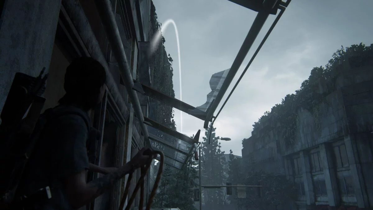 Ellie wirft ein Kabel durch ein zerbrochenes Fenster in The Last of Us Part 2.