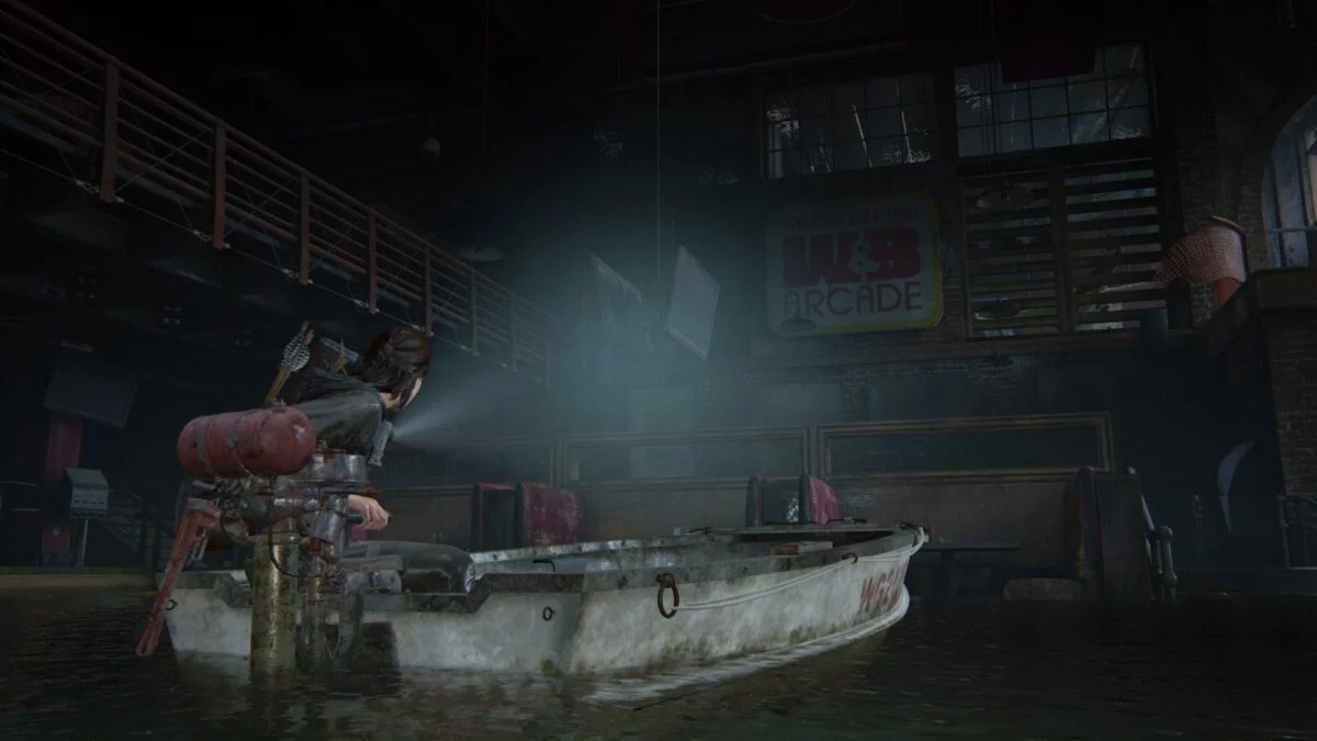 Ellie fährt in The Last of Us 2 mit einem Boot in eine überschwemmte Spielhalle.