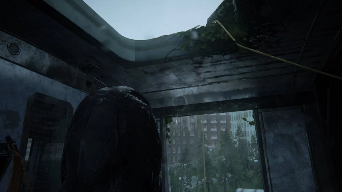 Ellie wirft in The Last of Us 2 ein Kabel durch die Dachluke eines Waggons.