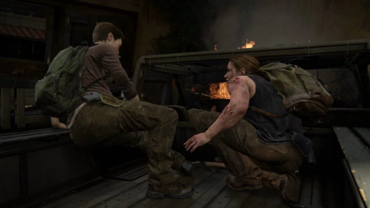 Abby und Mel sitzen in The Last of Us 2 auf der Ladefläche eines brennenden Trucks.