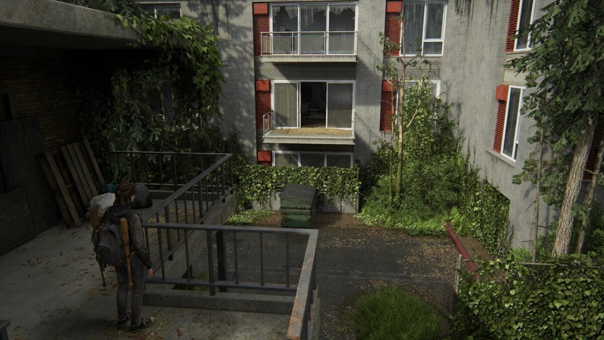 Ellie looks at the apartment next to the Capitol Inn in The Last of Us 2.