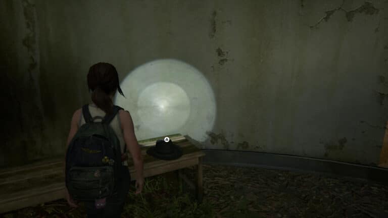 Another hat lies on the wooden bench in the showroom in The Last of Us 2.