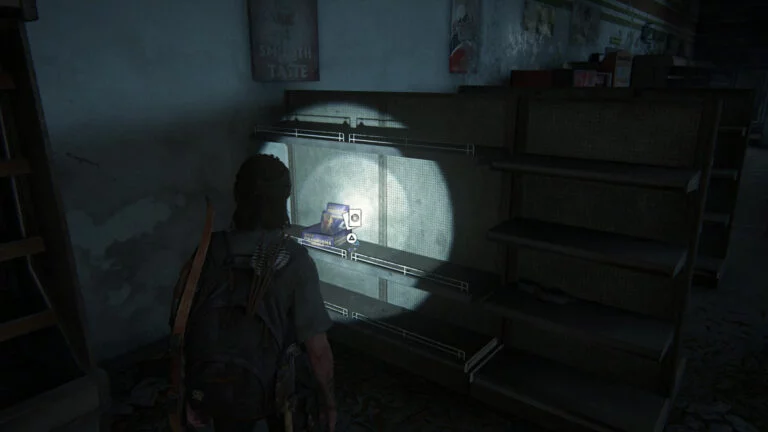 Die Sammelkarte Randy Styles neben einem Karten-Display in einem Regal eines Supermarkts in The Last of Us 2