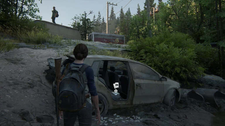 Die junge Ellie entdeckt die Sammelkarte The Austringer auf dem Rücksitz eines Autos in The Last of Us 2.