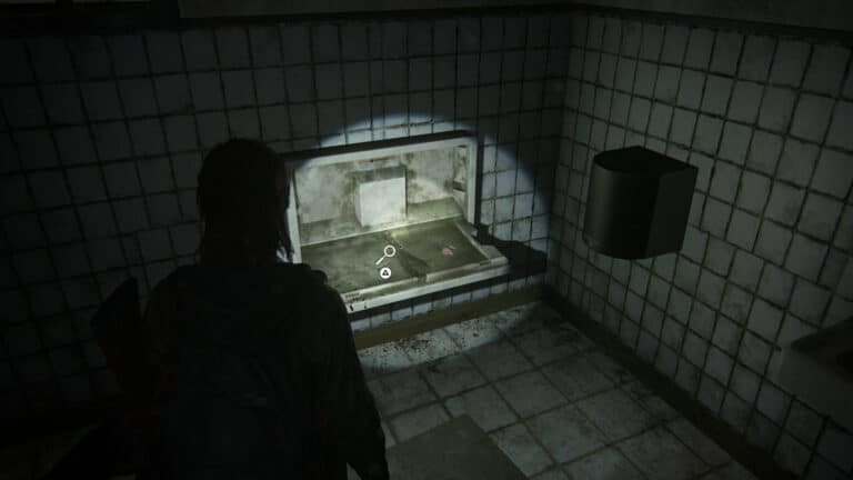 On the folding table in the toilet is the artifact Pet Store Key in The Last of Us 2.