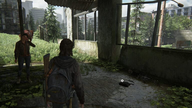The artifact Cache Hunter Note can be found inside a bag that lies on the ground among the ruined houses.