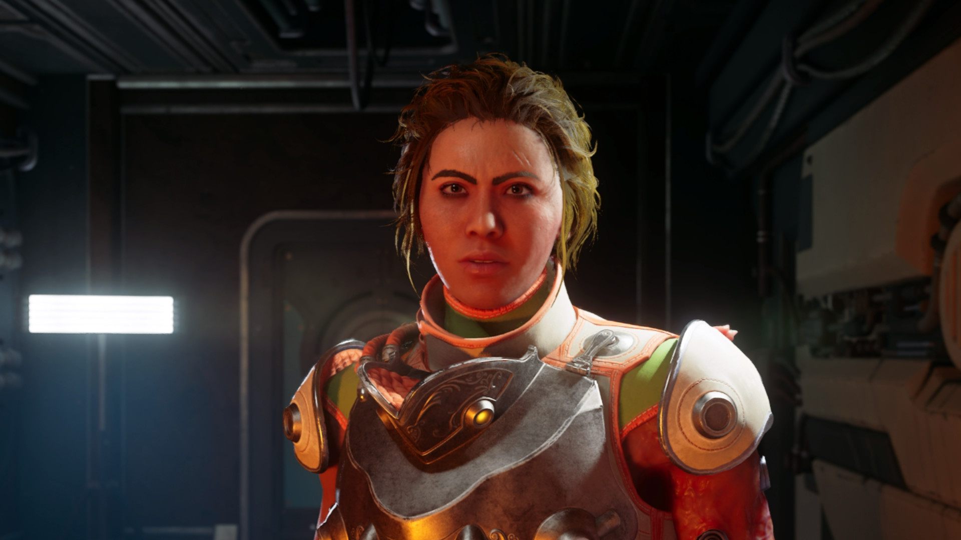 Eine Frau in futuristischer Rüstung steht in einem Raumschiff und schaut den Spieler direkt an – Spielszene aus The Outer Worlds 2.