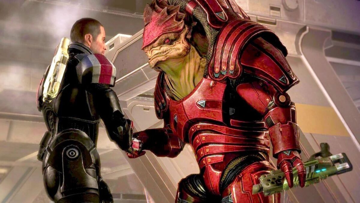 News Mass Effect Mensch in Rüstung gibt massigem Alienmann in roter Rüstung die Hand